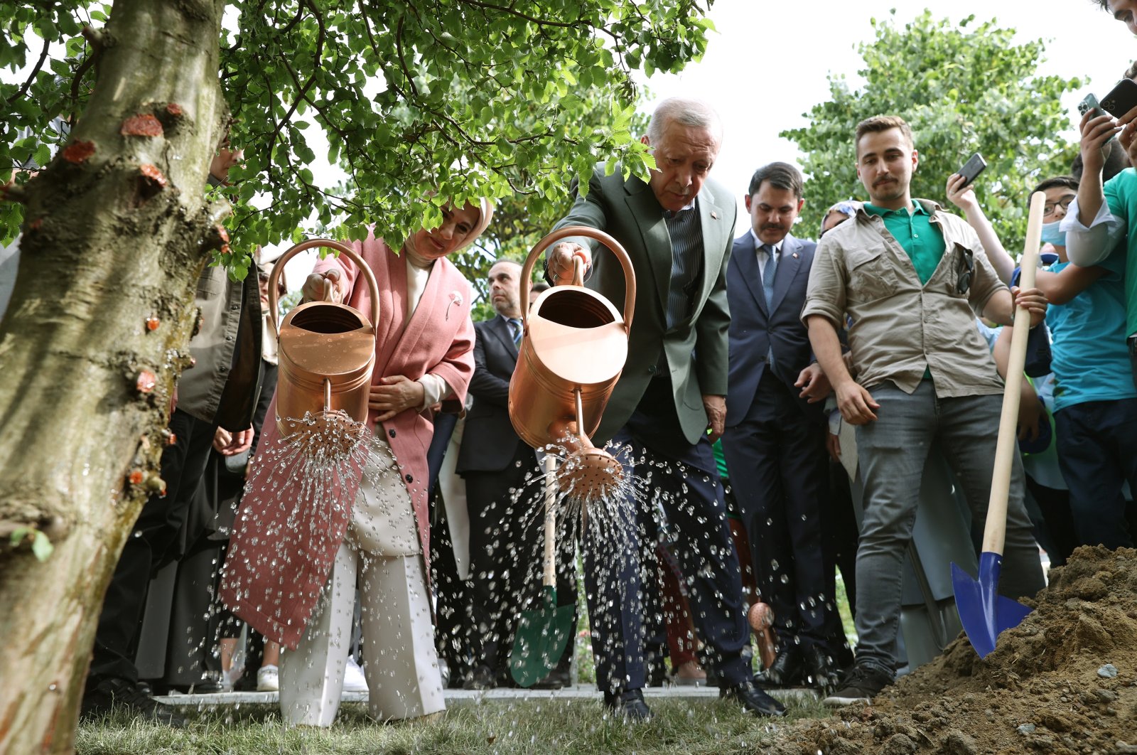 President Recep Tayyip Erdoğan and first lady Emine Erdoğan water a sapling they planted, in Istanbul, Turkey, May 29, 2022. (AA PHOTO) 