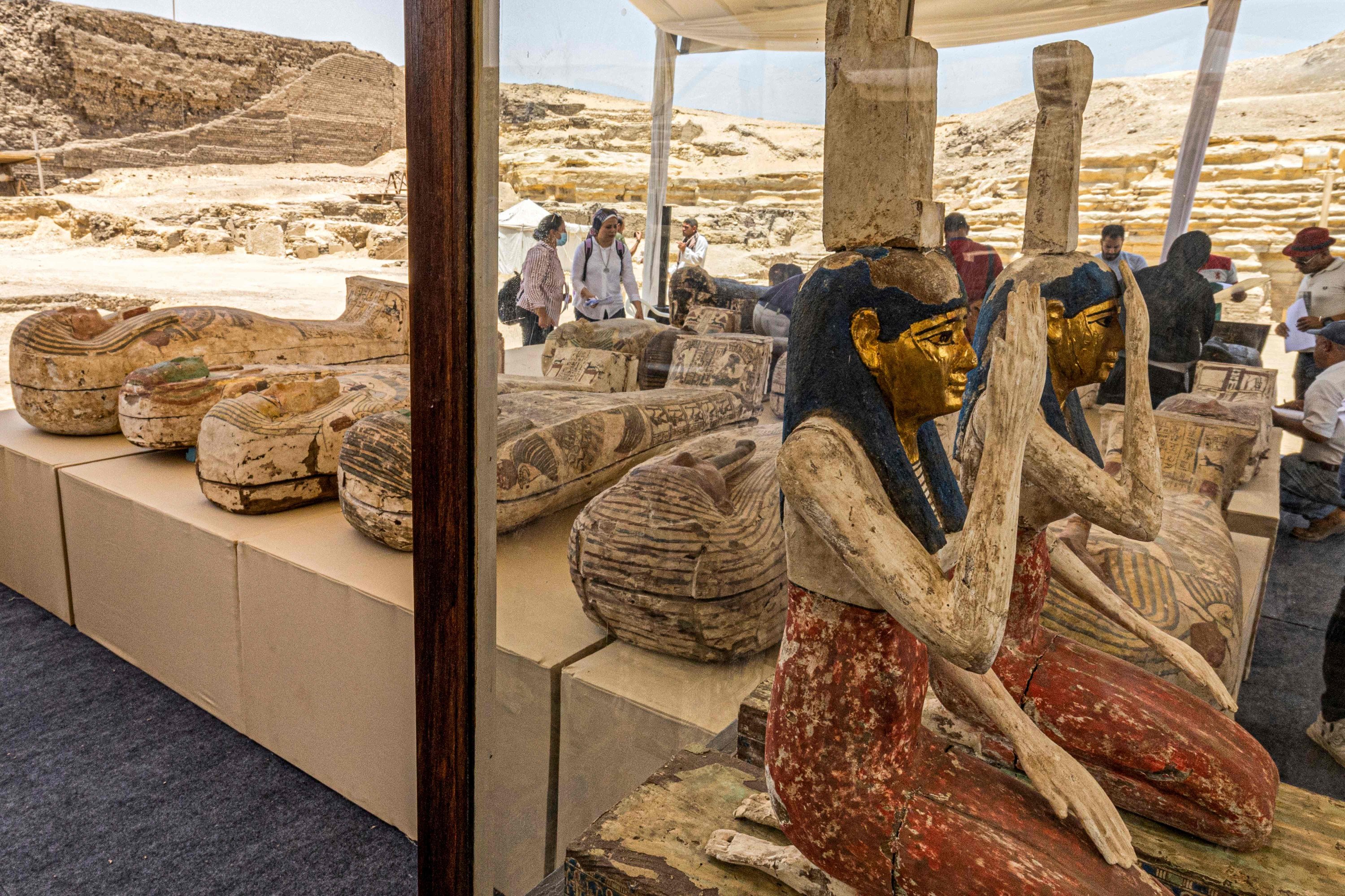 Statuettes depicting the Egyptian goddesses (L to R) Isis (Iset) and Nephthys (Nebet-Het) and other sarcophagi found in a cache dating to the Egyptian Late Period (around the fifth century BC) are displayed after their discovery by a mission headed by Egypt's Supreme Council of Antiquities, at the Bubastian cemetery at the Saqqara necropolis, Cairo, Egypt, May 30, 2022. (AFP Photo)