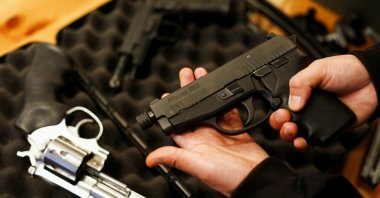 A legal owner poses with his 9 mm Sig Sauer P239 after Canada's government introduced legislation to implement a "national freeze" on the sale and purchase of handguns as a part of a gun-control package, British Columbia, Canada, May 30, 2022. (Reuters Photo)