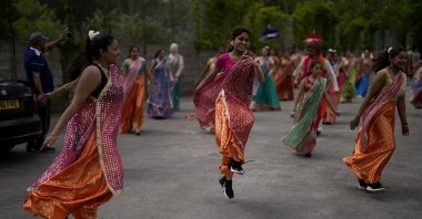 Performers take part in a rehearsal for their upcoming Bollywood-style performance entitled "The Wedding Party," at Northolt High School, in north west London, U.K., May 29, 2022. (AP Photo)