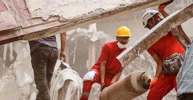 Red Crescent members work in the aftermath of the collapse of a 10-story building in Abadan, Khuzestan province, Iran, May 24, 2022. (Iranian Red Crescent Handout Photo via EPA)