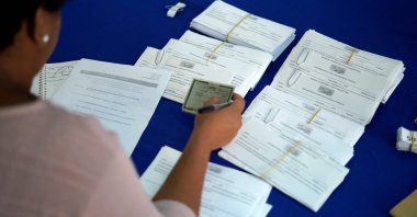 A woman checks the documents of a man who is applying for a job announced during a weekly job fair at the Telecommunications Workers Union in Rio de Janeiro, Brazil, June 28, 2019. (AFP Photo)