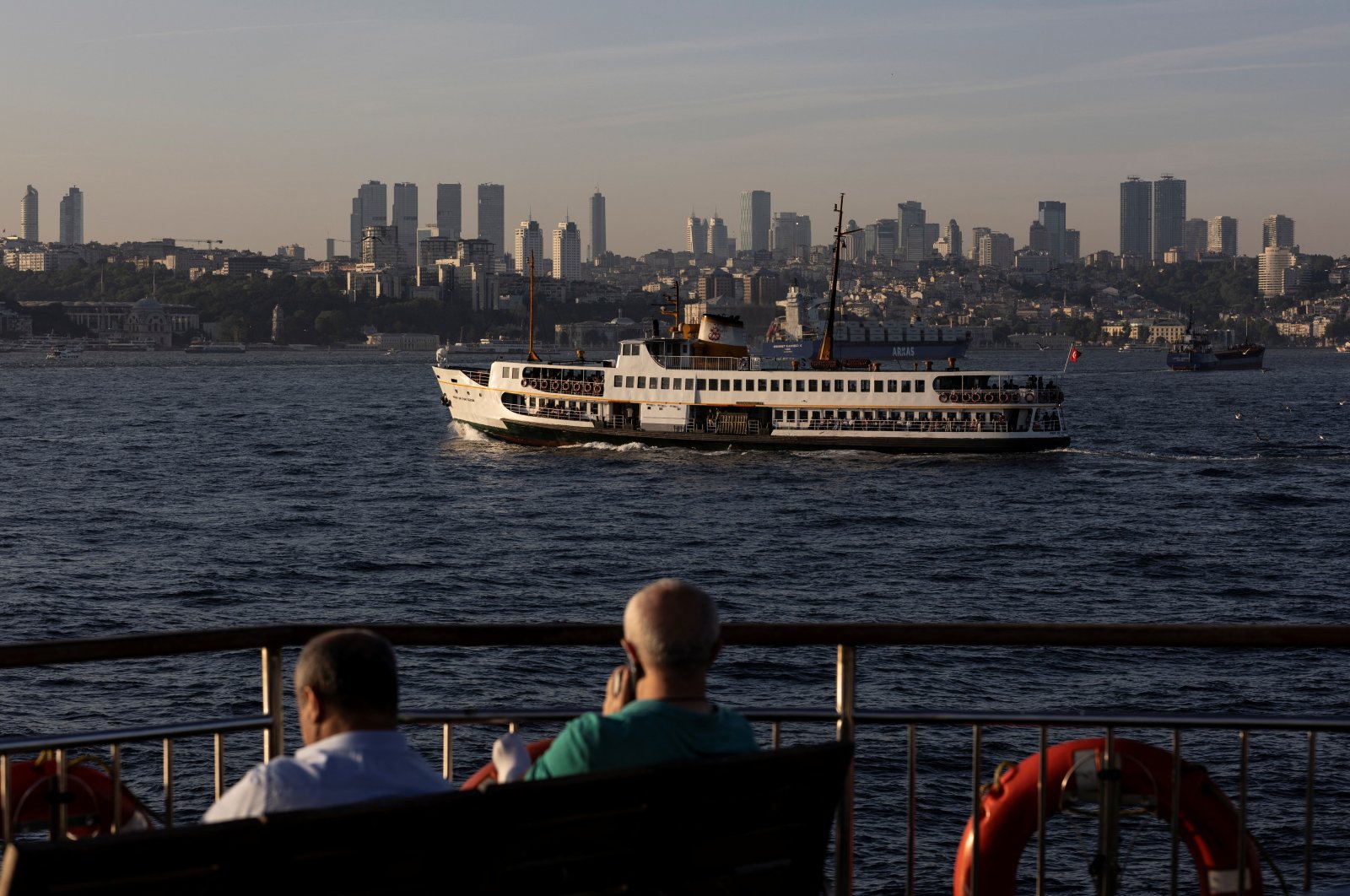 Commuters enjoy a sunny afternoon on board a ferry as another one sails in the Bosporus in Istanbul, Turkey, May 27, 2022. (Reuters Photo)