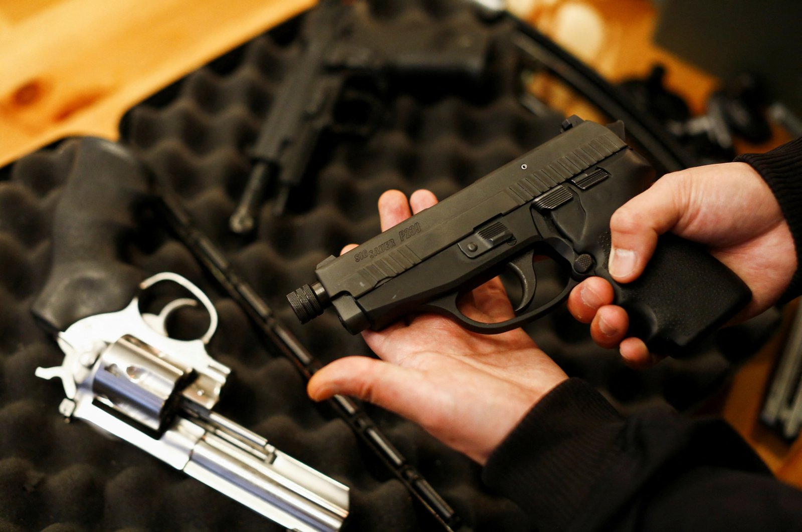 A legal owner poses with his 9 mm Sig Sauer P239 after Canada&#039;s government introduced legislation to implement a &quot;national freeze&quot; on the sale and purchase of handguns as a part of a gun-control package, British Columbia, Canada, May 30, 2022. (Reuters Photo)