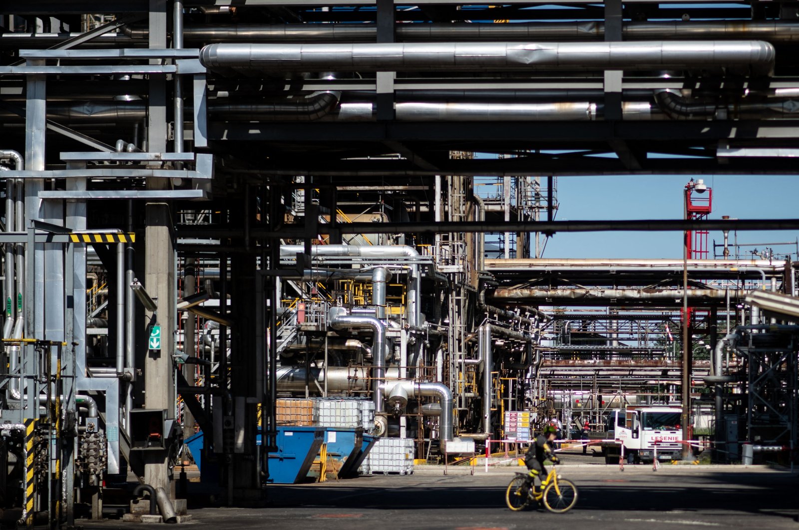 A worker rides a bike at the facilities of Slovak refinery Slovnaft in Bratislava, Slovakia, May 19, 2022. (AFP Photo)