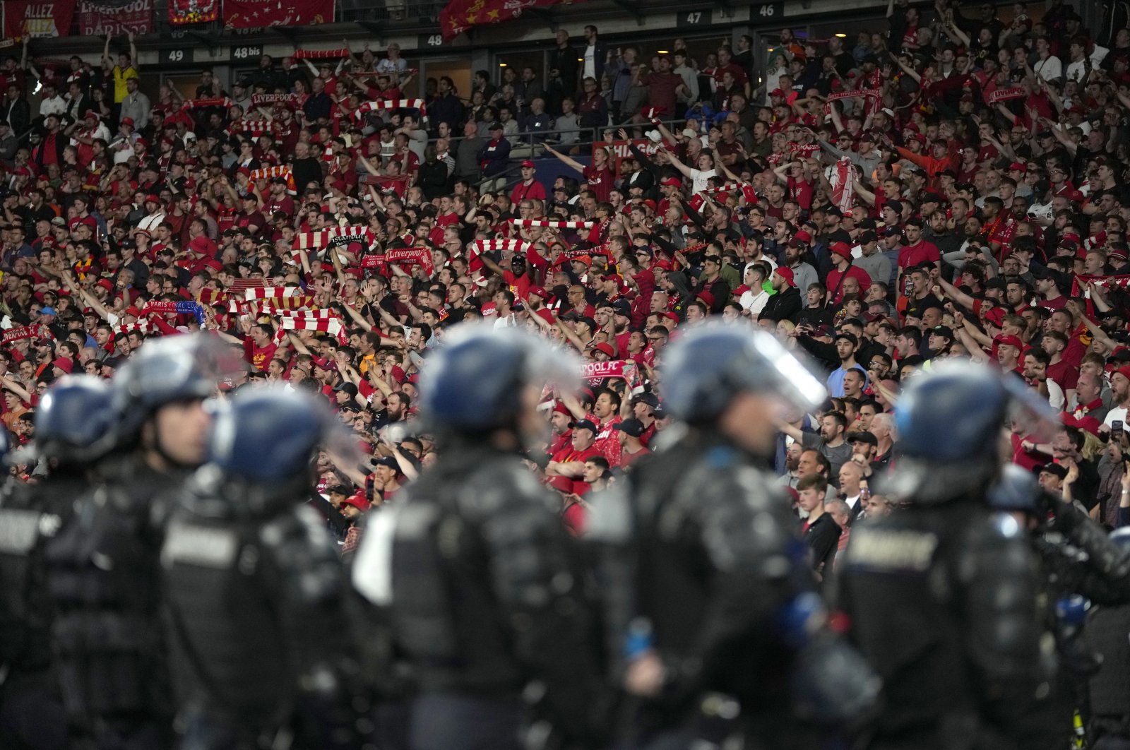Riot police watch Liverpool fans during the Champions League final soccer match between Liverpool and Real Madrid at the Stade de France in Paris, France, May 28, 2022. (AP Photo)