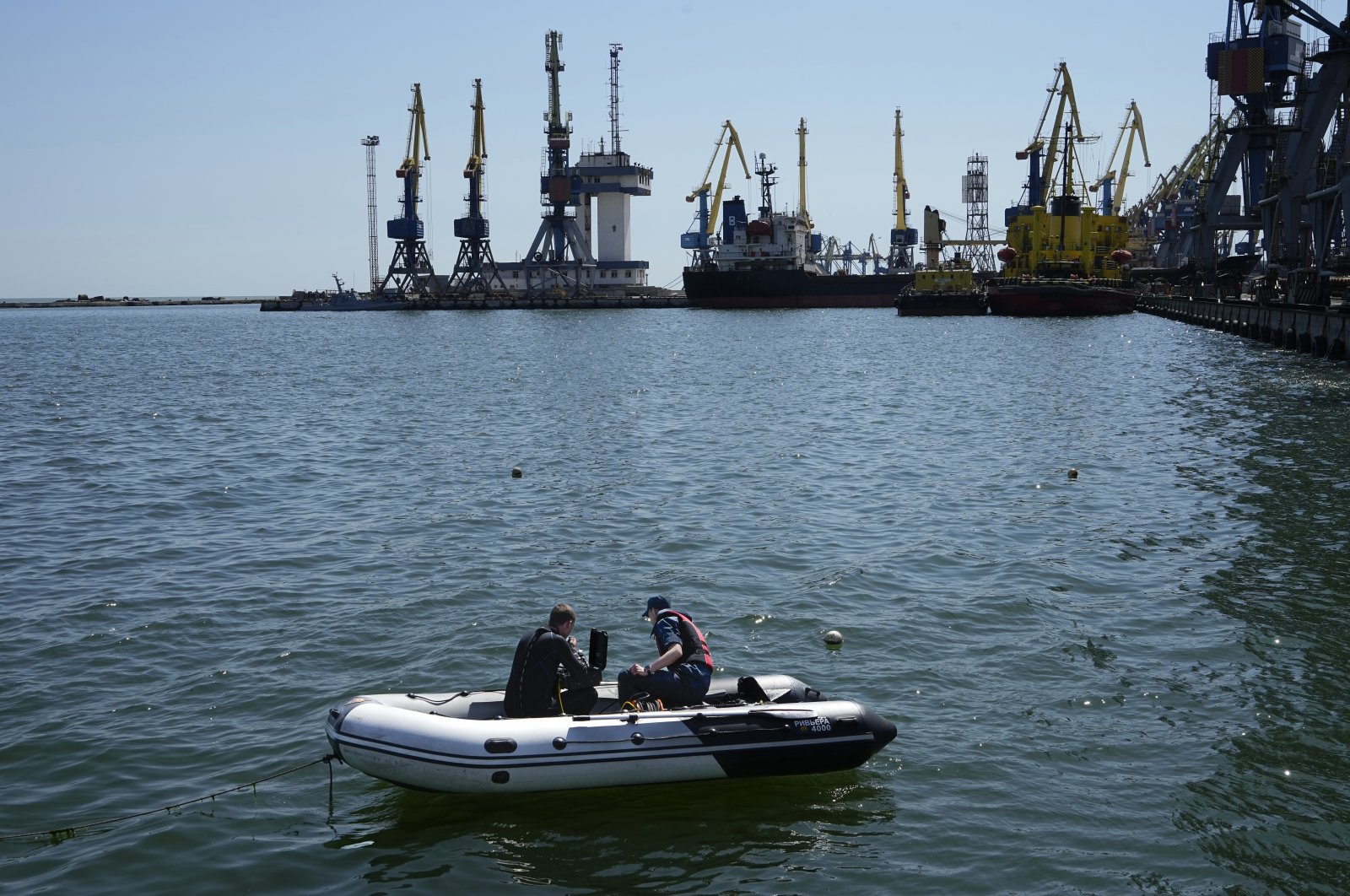 Officials work to defuse a mine in an area of the Mariupol Sea Port in Mariupol, eastern Ukraine, April 29, 2022. (AP Photo)
