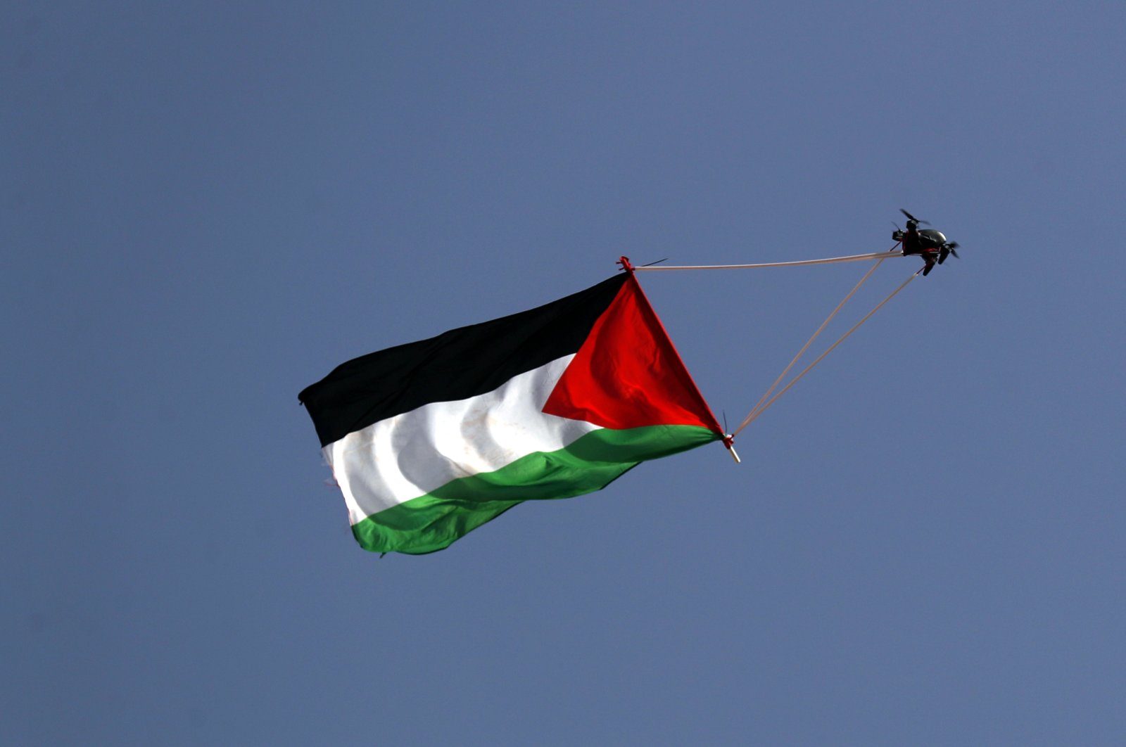 A drone carrying a Palestinian flag flies over the walls of Jerusalem&#039;s Old City, during the Israeli right-wing &quot;Flag March&quot; next to the Damascus gate in occupied East Jerusalem, Palestine, May 29, 2022. (EPA Photo)