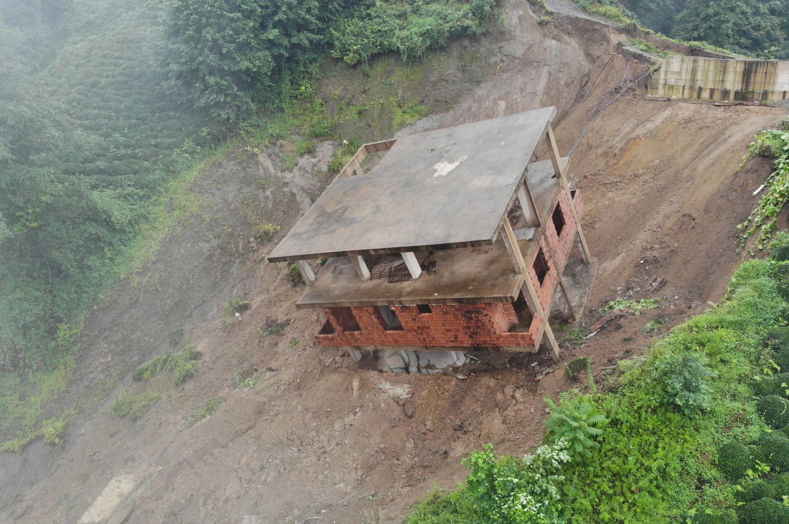A view of a building that slid down the slope after a landslide, in Rize, northern Turkey, Aug. 14, 2021. (IHA PHOTO)