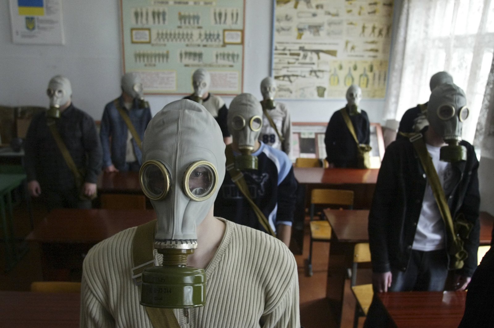 Schoolchildren wear gas masks during nuclear safety training lessons in Rudo, near the isolated zone around Chernobyl nuclear power plant, Ukraine, April 3, 2006. (AP Photo)