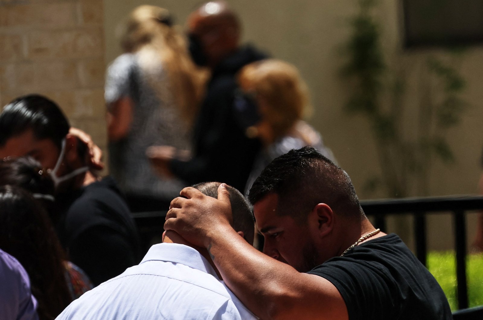People comfort each other outside the Sacred Heart Catholic Church after attending the funeral service of Amerie Jo Garza, one of the victims of the Robb Elementary school mass shooting that resulted in the deaths of 19 children and two teachers, in Uvalde, Texas, U.S., May 31, 2022. (Reuters Photo)