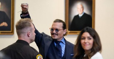 Actor Johnny Depp gestures to spectators in court after closing arguments at the Fairfax County Circuit Courthouse in Fairfax, Virginia, U.S., May 27, 2022. (AFP Photo)