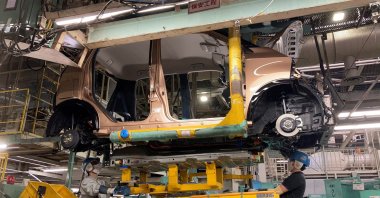 Workers install a battery for a new electric vehicle model at Mitsubishi Motor Corp's factory in Kurashiki, Japan, May 19, 2022. (Reuters Photo)