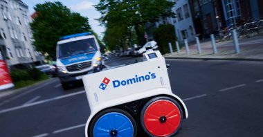 The Domino&#039;s pizza delivery robot crossing a street in Berlin, Germany, May 2, 2022. (DPA Photo)