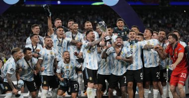 Argentina's Lionel Messi holds a trophy as he celebrates with his teammates after winning the Finalissima soccer match between Italy and Argentina at Wembley Stadium in London , Wednesday, June 1, 2022. (AP Photo)