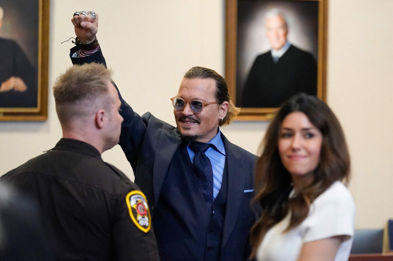 Actor Johnny Depp gestures to spectators in court after closing arguments at the Fairfax County Circuit Courthouse in Fairfax, Virginia, U.S., May 27, 2022. (AFP Photo)