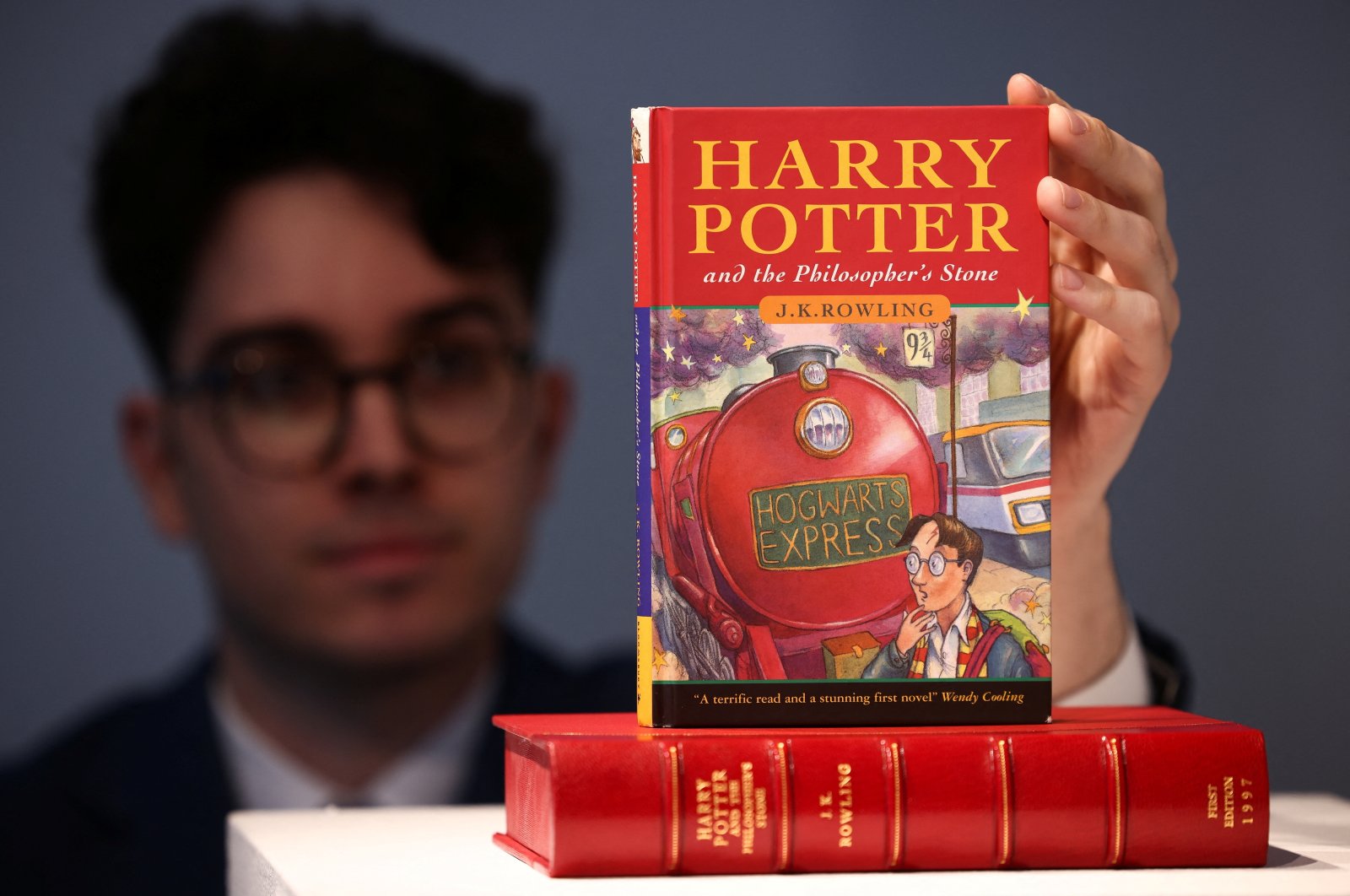 Rare books specialist and curator Mark Wiltshire poses with a rare first edition of &quot;Harry Potter and the Philosophers Stone&quot; signed by British author J.K. Rowling, which is to be put up for auction at Christie&#039;s auction house in London, U.K., May 31, 2022. (Reuters Photo)