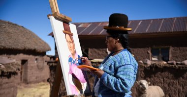 Claudia Callizaya, 32, a Bolivian painter known as Claudina, applies final touches to her work, cholita-style Mona Lisa painting, at her house in Kalla Baja, Bolivia, May 29, 2022. (Reuters Photo)