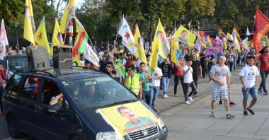 Pro-PKK protesters wave flags of the terrorist organization and a picture of imprisoned terrorist leader Abdullah Öcalan is seen on a vehicle in the Austrian capital Vienna, June 28, 2020. (AA Photo)