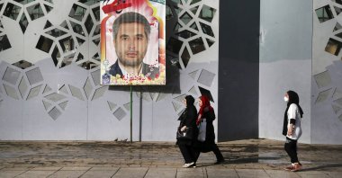 People walk past a banner showing Iran&#039;s Revolutionary Guard Col. Hassan Sayad Khodayari who was killed, prior to his funeral ceremony, Tehran, Iran, May 24, 2022. (AP Photo)