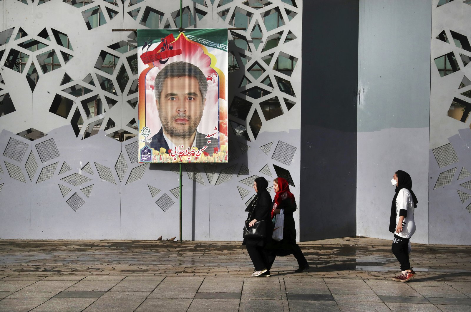 People walk past a banner showing Iran&#039;s Revolutionary Guard Col. Hassan Sayad Khodayari who was killed, prior to his funeral ceremony, Tehran, Iran, May 24, 2022. (AP Photo)