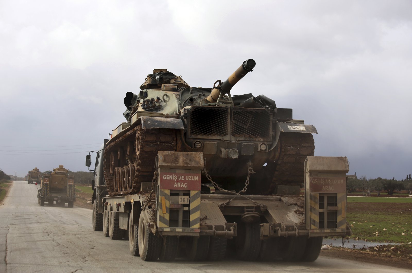 Turkish military convoy drives through the village of Binnish, in Idlib province, Syria, Feb. 8, 2020. (AP)