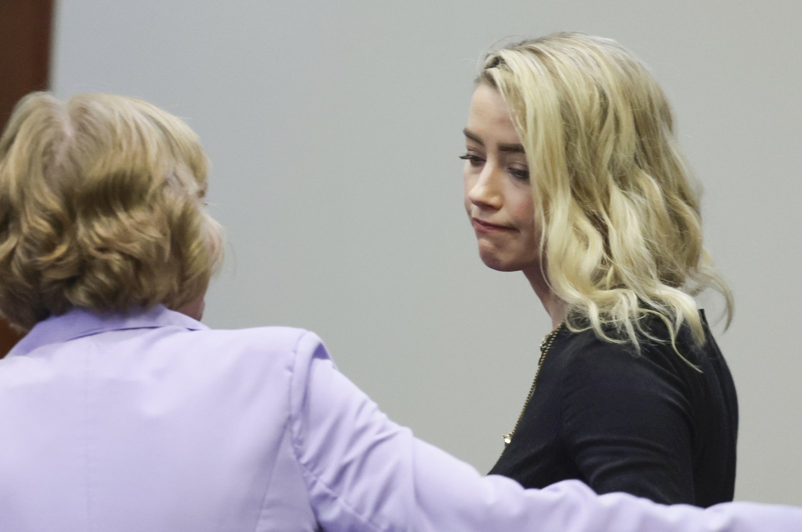 Actor Amber Heard reacts with her lawyer Elaine Bredehoft after the verdict was read at the Fairfax County Circuit Courthouse in Fairfax, Virgina, U.S., June 1, 2022. (AP Photo)