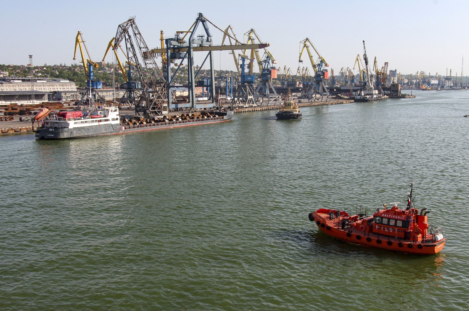 A Russian vessel (top L) prepares to depart from the Mariupol Sea Port in Mariupol, eastern Ukraine, May 31, 2022. (AP Photo)