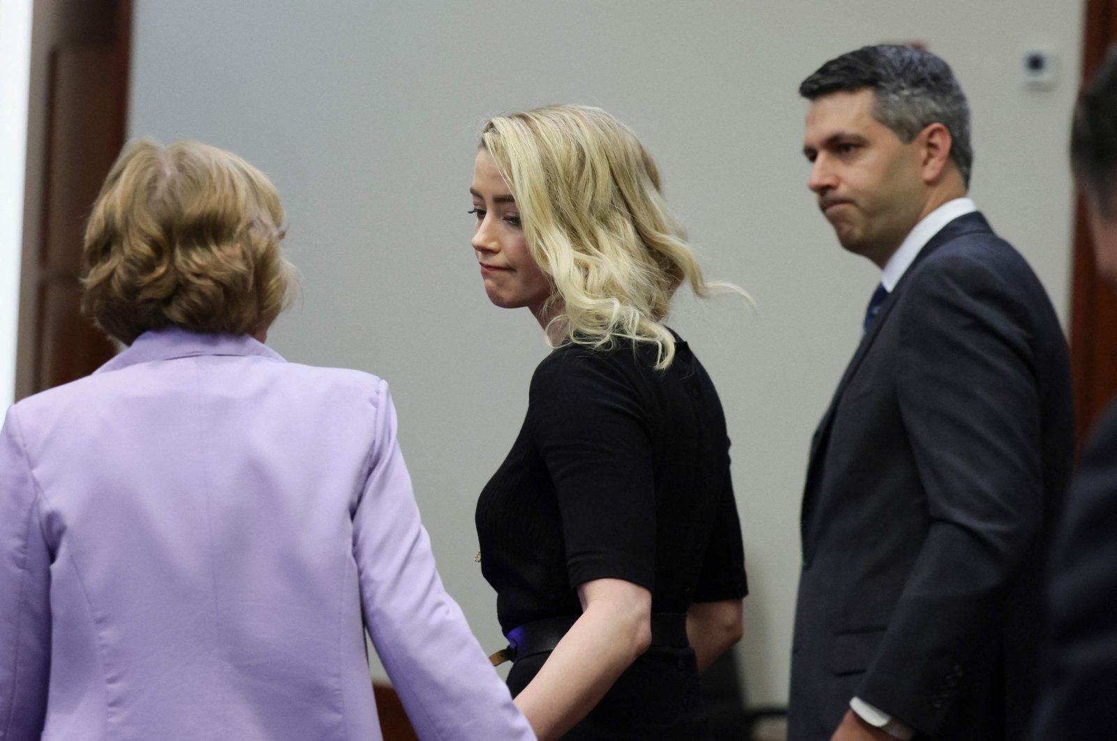 U.S. actor Amber Heard looks to her lawyer Elaine Bredehoft after the jury announced a split verdict in favor of both Johnny Depp and Amber Heard on their claim and counter-claim in the Depp v. Heard civil defamation trial at the Fairfax County Circuit Courthouse in Fairfax, Virginia, U.S., June 1, 2022. (AFP Photo)
