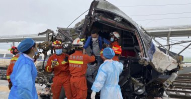 In this photo released by China's Xinhua News Agency, emergency personnel help a passenger off a damaged train car after it derailed in Rongjiang County in southwestern China's Guizhou Province, June 4, 2022. (AP Photo)