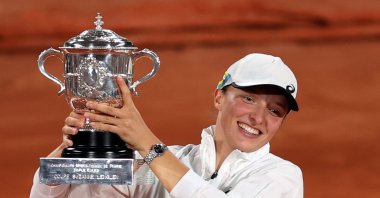 Iga Swiatek of Poland poses with her trophy after winning against Coco Gauff of the U.S. in their women's final match during the French Open tennis tournament in Paris, France, June 4, 2022. (EPA Photo)