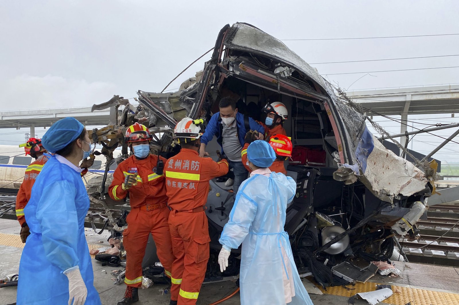 In this photo released by China&#039;s Xinhua News Agency, emergency personnel help a passenger off a damaged train car after it derailed in Rongjiang County in southwestern China&#039;s Guizhou Province, June 4, 2022. (AP Photo)