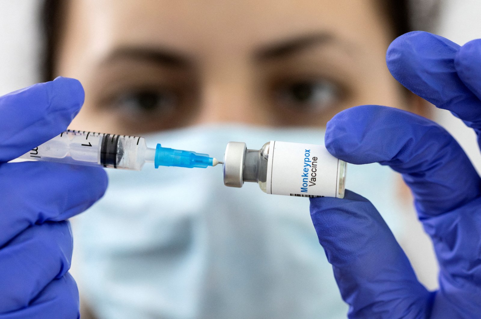 A woman holds a mock-up vial labeled &quot;Monkeypox vaccine&quot; and a medical syringe in this illustration taken on May 25, 2022. (Reuters File Photo)