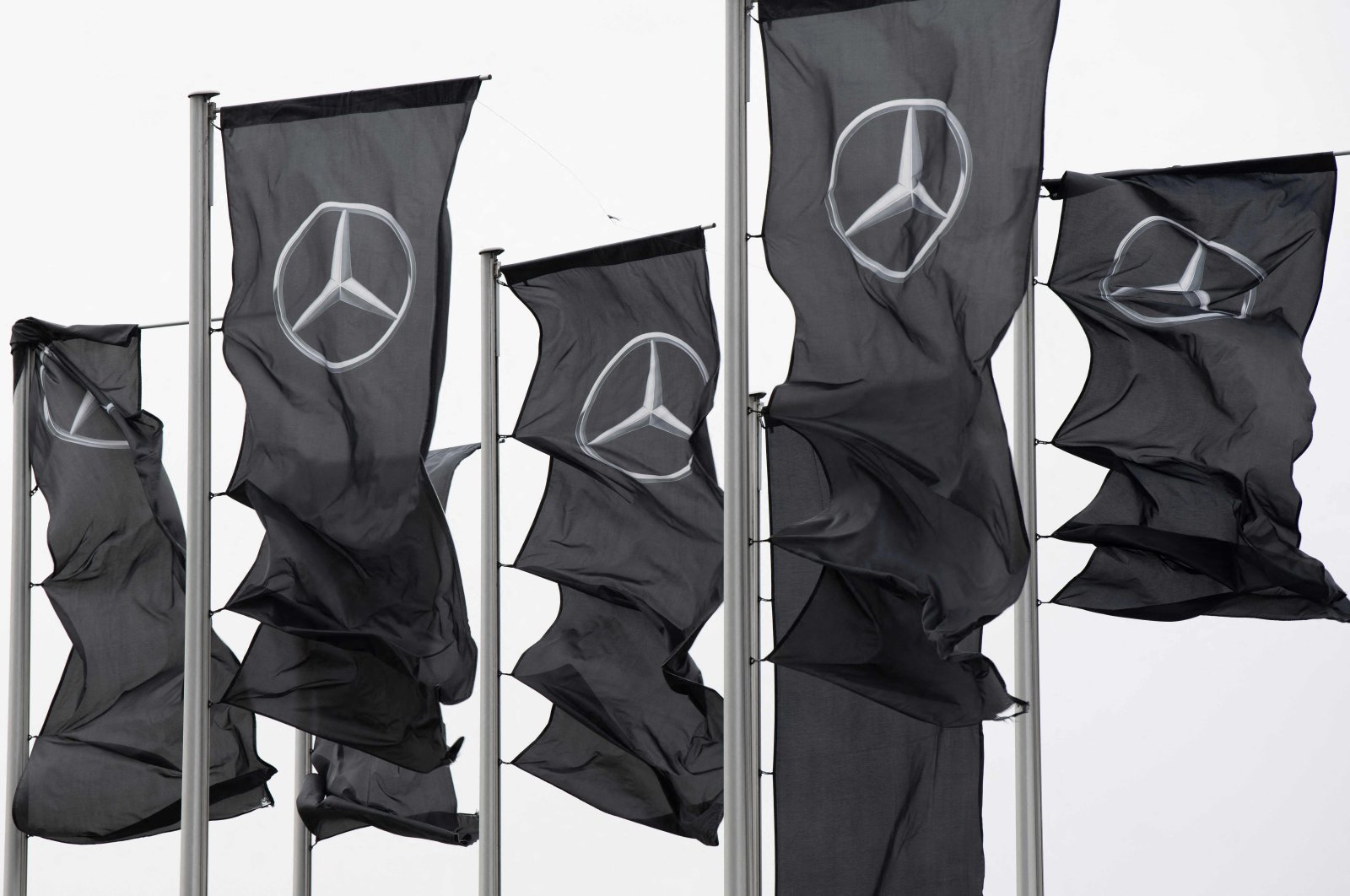 Flags with the Mercedes-Benz logo are seen in front of the Mercedes-Benz Museum in Stuttgart, southern Germany, Feb. 1, 2022. (AFP Photo)
