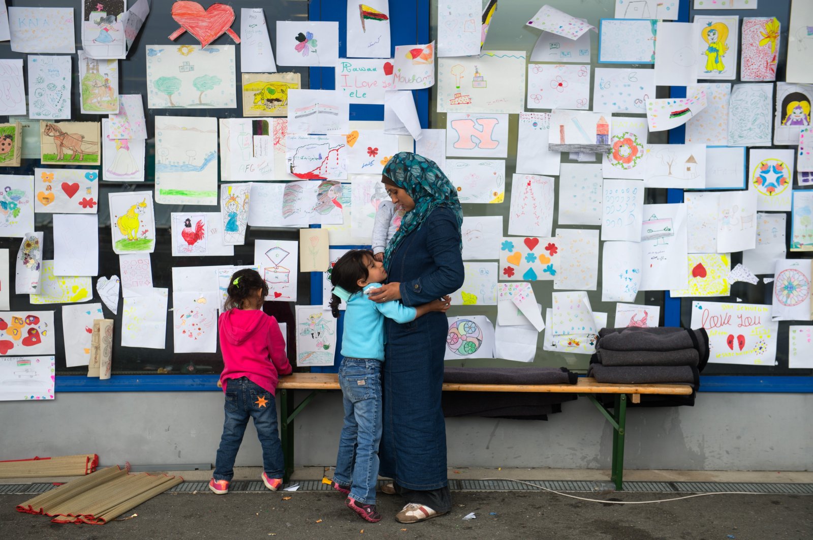 A migrant child hugs his mother during Eid al-Adha in a shelter at a former shopping mall in Graz, about 190 kilometers (118 miles) south of Vienna, Austria, Sept. 24, 2015. (AP File Photo)