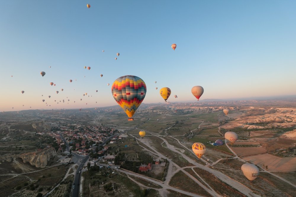A traditional view of a large group of hot air balloons flying at dawn in Cappadocia to admire rock formations, Göreme, Turkey, Aug. 31, 2019.