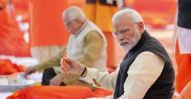 Indian Prime Minister Narendra Modi, front, performs Hindu rituals sitting at Sangam, the confluence of the Rivers Ganges and Yamuna, at Allahabad, India, Dec. 16, 2018. (AP Photo)