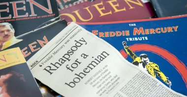 Newspaper cuttings about the death of the singer Freddie Mercury at the time on a backdrop of Queen memorabilia can be seen in this undated photo. (Alamy via Reuters)