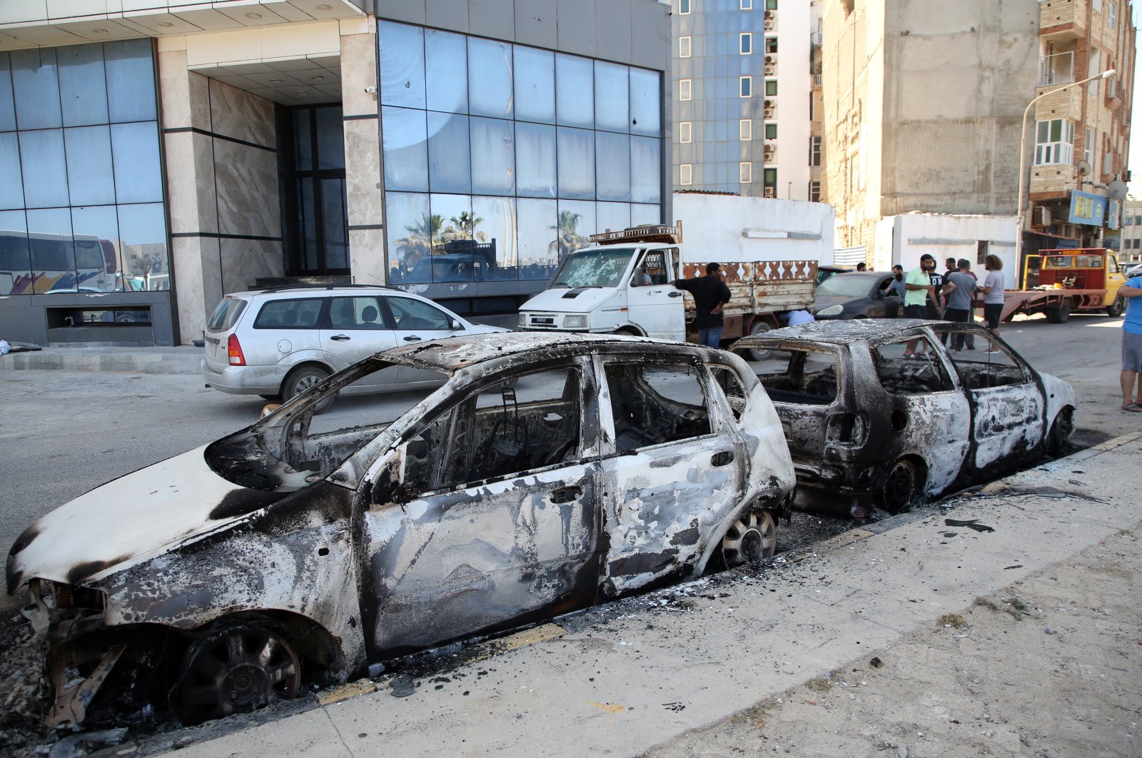 Vehicles damaged after overnight clashes between fighters loyal the Tripoli-based government and the Tobruk-based one in Tripoli, Libya, 17 May 2022. (EPA)