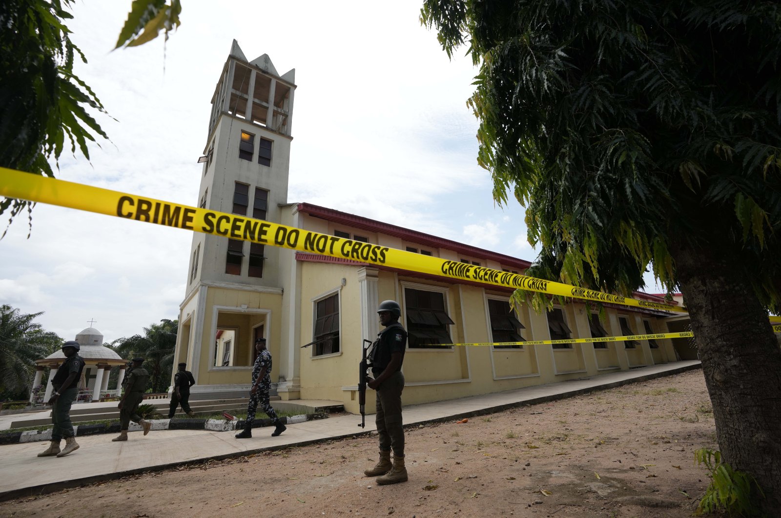 Nigerian police stand guard outside of the St. Francis Catholic church in Owo, Nigeria on June 6, 2022, a day after an attack that targeted worshippers. (AP Photo)