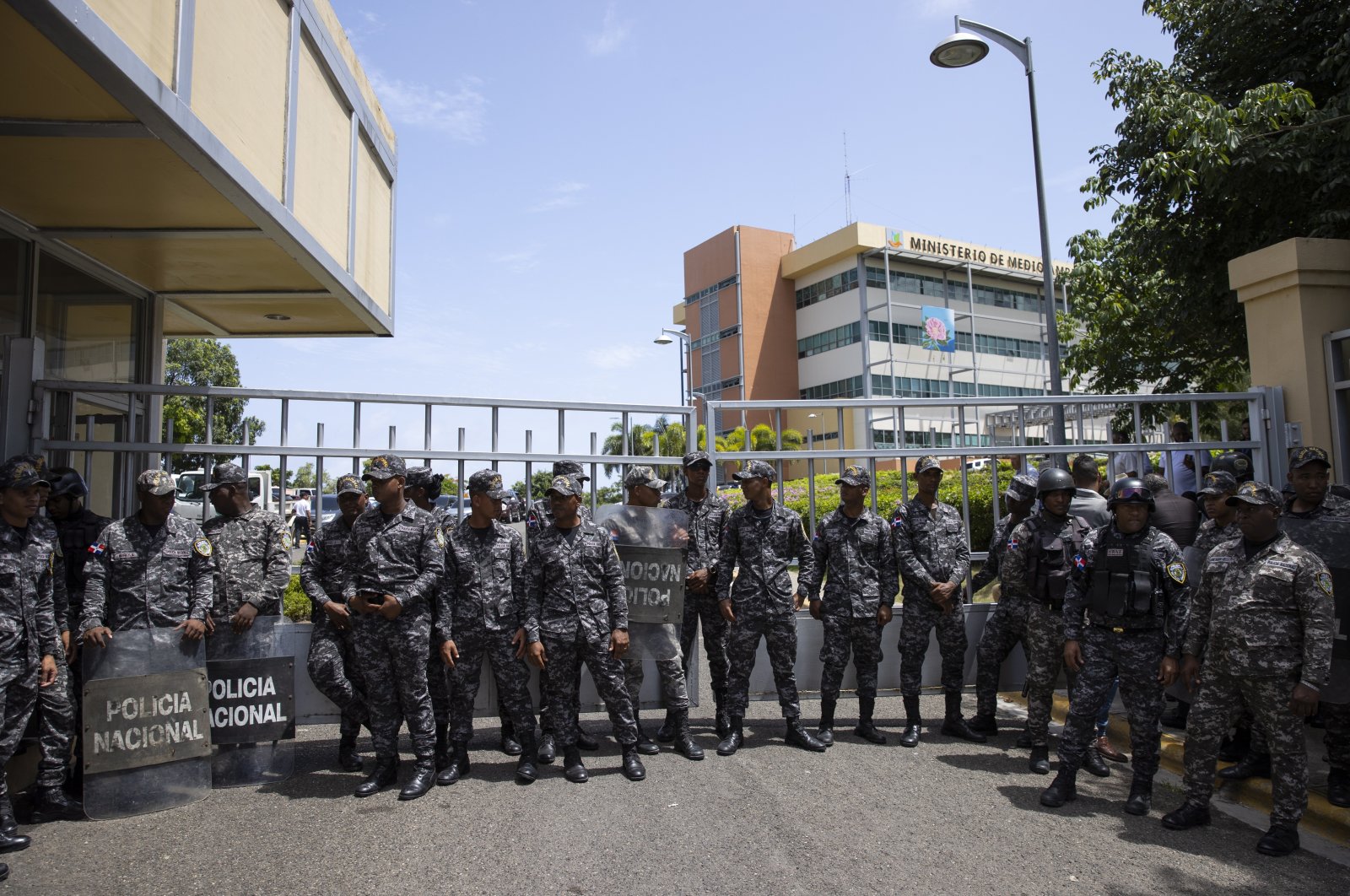Agents of the National Police monitor the Environment and Natural Resources Ministry stand guard after a shooting, in Santo Domingo, Dominican Republic, June 6, 2022. (EPA Photo)