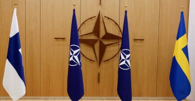 A view of the flags of Finland, NATO and Sweden during a ceremony to mark Sweden's and Finland's application for membership in Brussels, Belgium, May 18, 2022. (REUTERS)