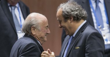Then FIFA President Sepp Blatter (L) is greeted by UEFA President Michel Platini (R) in Zurich, Switzerland, May 29, 2015. (AP Photo)