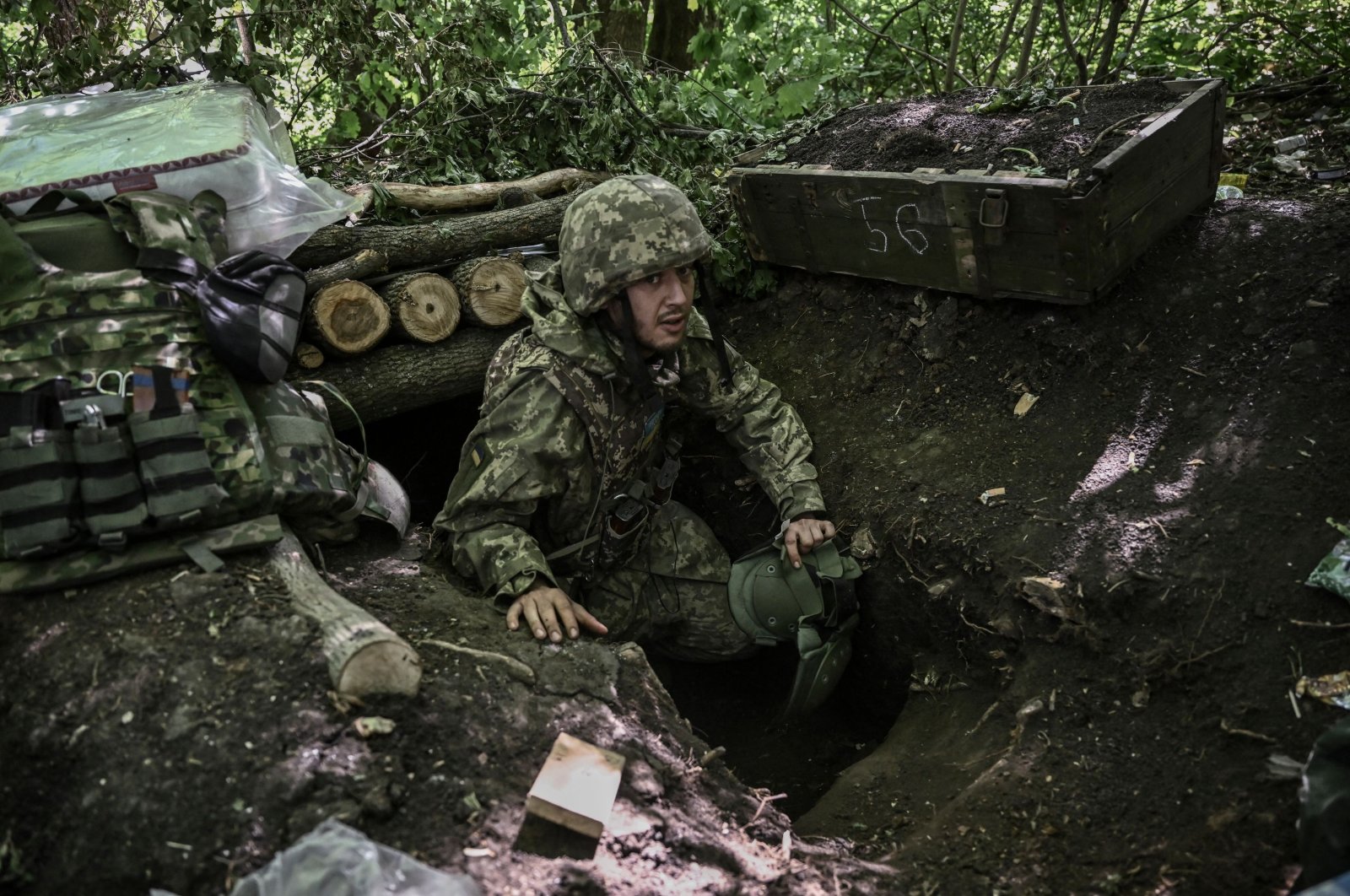 A Ukrainian serviceman gets out of an underground makeshift bunker after shelling at a field camp near the front line at an undisclosed location in the eastern region of Donbass, Ukraine, June 6, 2022. (AFP Photo)