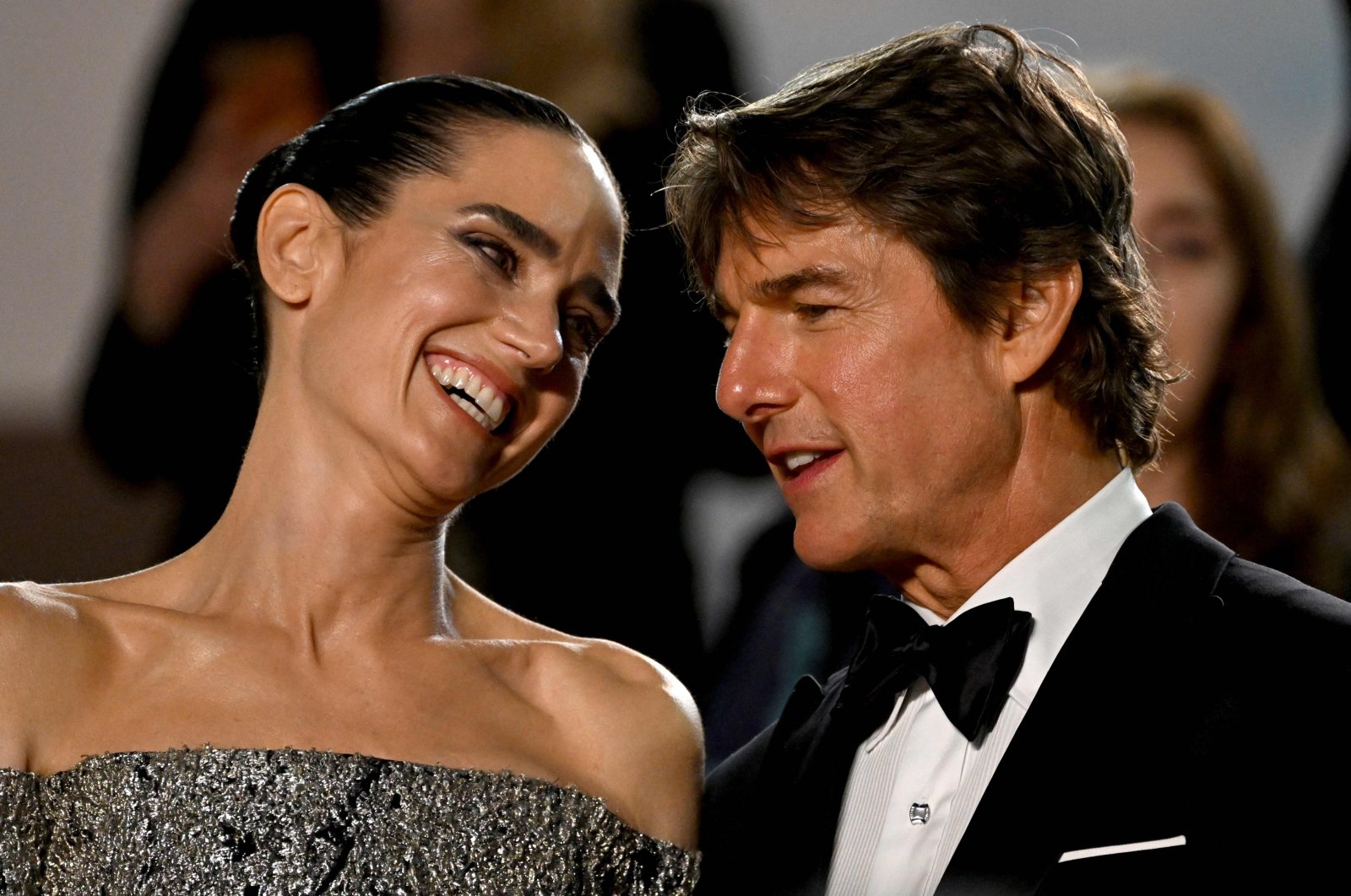 In this file photo taken on May 18, 2022, U.S. actors Jennifer Connelly (L) and Tom Cruise talk as they leave the Festival Palace following the screening of the film &quot;Top Gun: Maverick&quot; during the 75th edition of the Cannes Film Festival in Cannes, southern France. (AFP Photo)