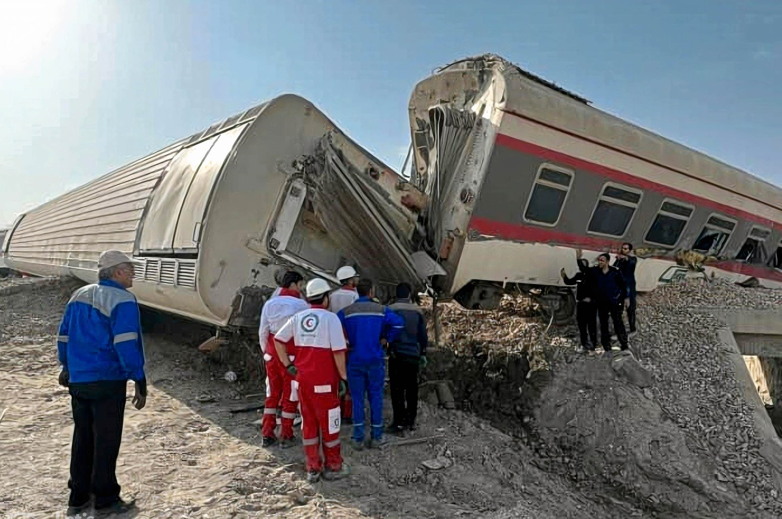 Rescuers at the scene of a train derailment near the central Iranian city of Tabas on the line between Mashhad and Yazd, ıran, June 8, 2022. (Iranian Red Crescent via AFP)