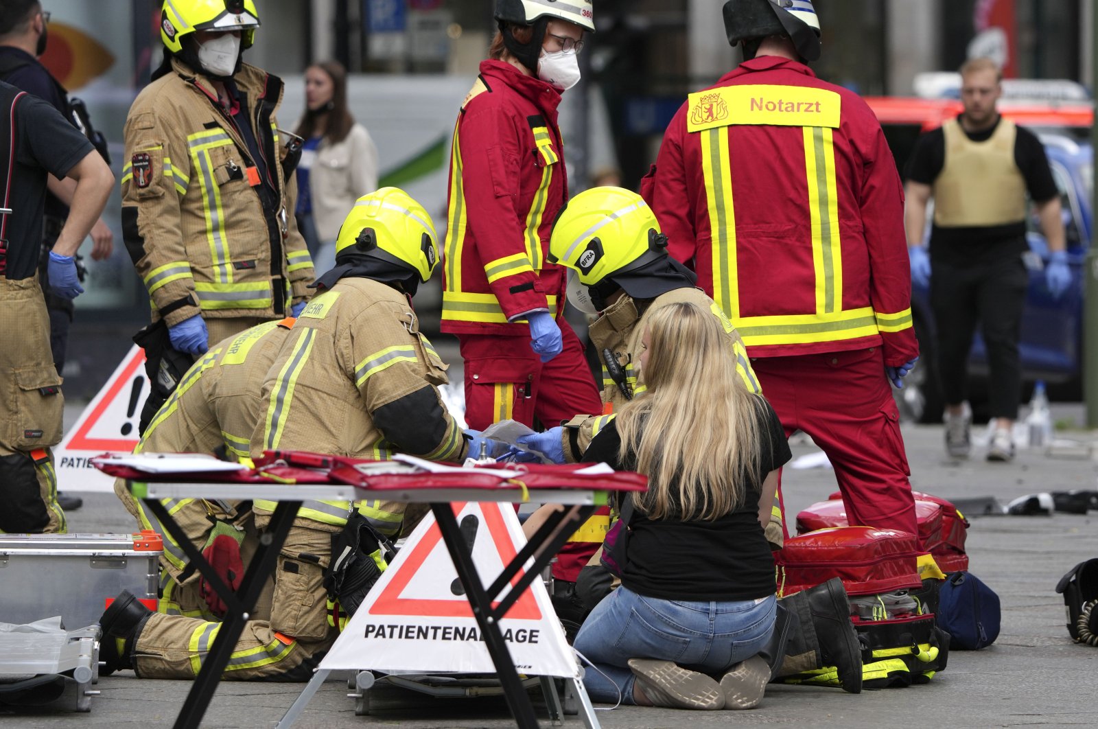 Rescue workers help an injured person after a car crashed into a crowd of people in central Berlin, Germany, June 8, 2022. (AP Photo)