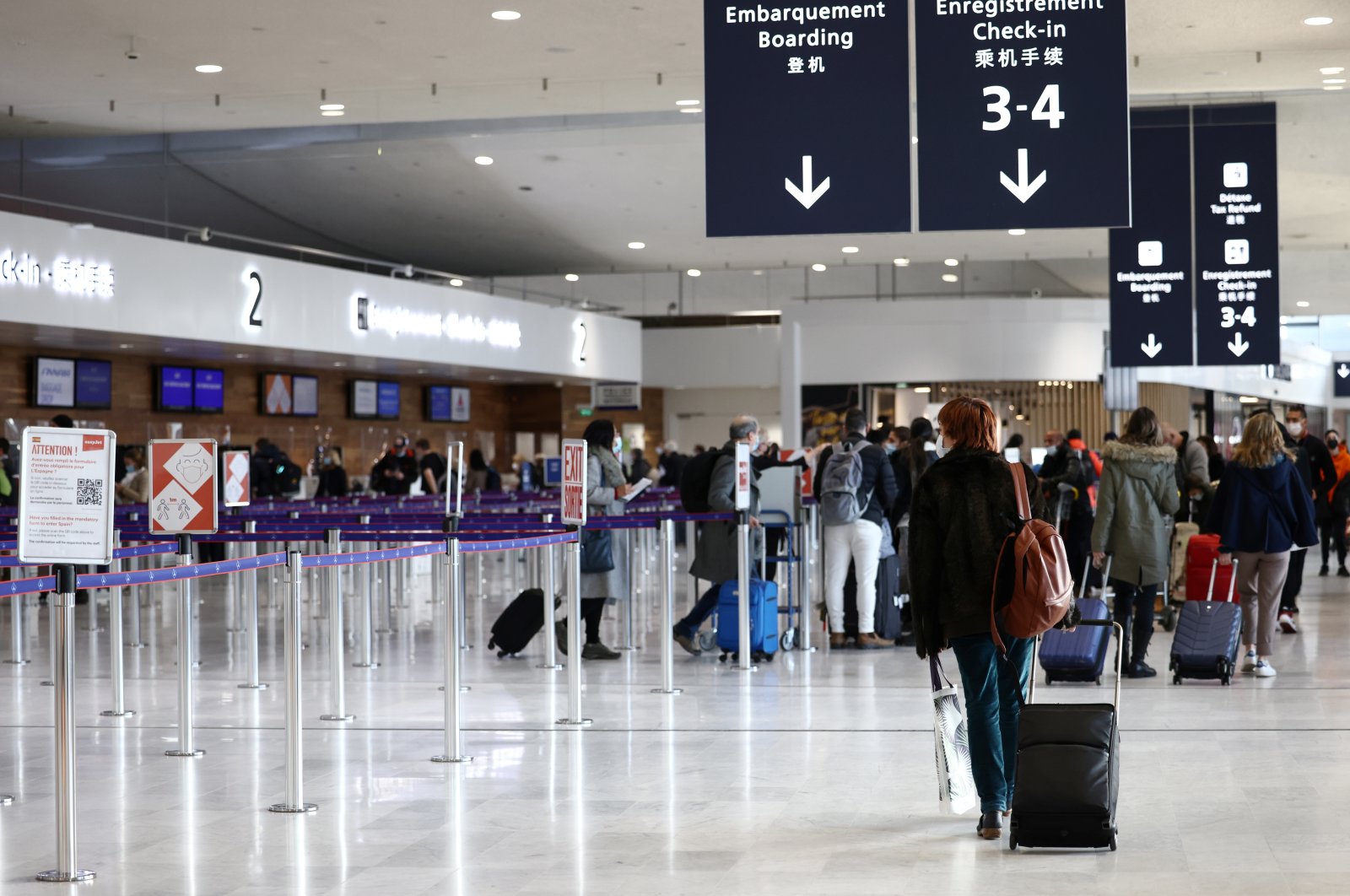 Passengers walk in the departures area of Terminal 2 at Paris Charles de Gaulle airport in Roissy-en-France near Paris, France, Dec. 2, 2021. (Reuters Photo)