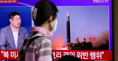 A woman watches a TV broadcasting a news report on North Korea's launch of three missiles including one thought to be an intercontinental ballistic missile (ICBM), in Seoul, South Korea, May 25, 2022. (Reuters Photo)