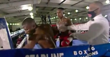 This social media screengrab shows South African boxer Simiso Buthelezi (L) throwing punches toward an empty corner of the ring during his fight against Siphesihle Mntungwa (C), Durban, South Africa, June 5, 2022.